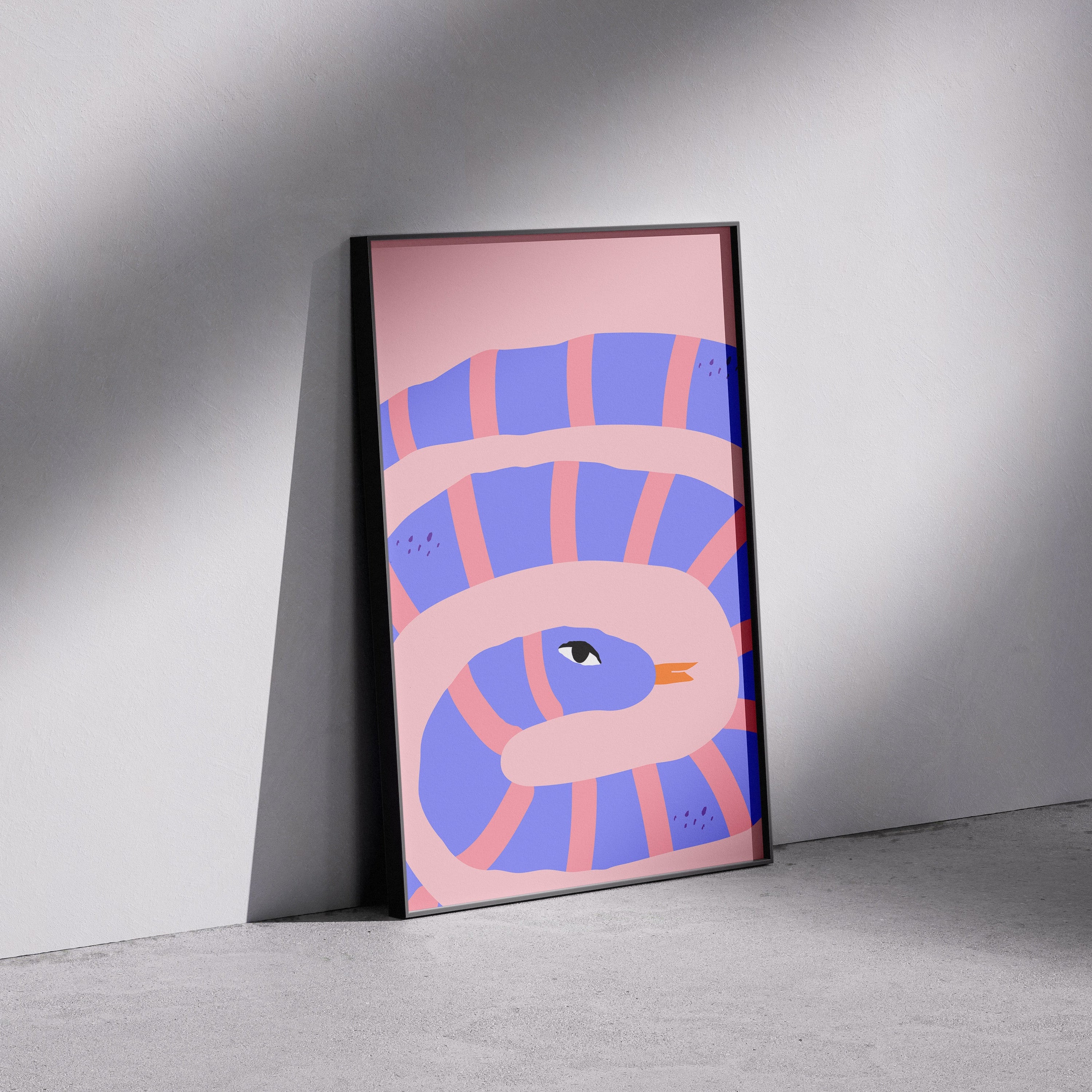 Framed abstract artwork with pink and blue design on a gray wall.